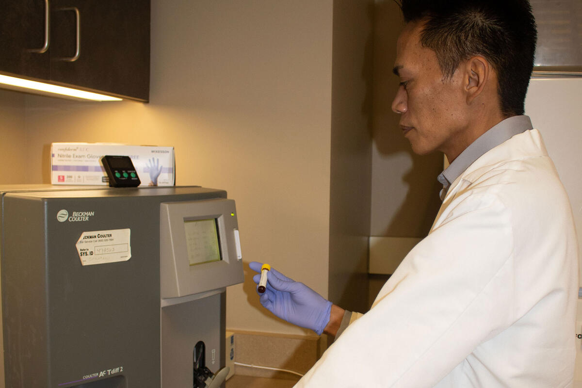 A man looking at a blood sample