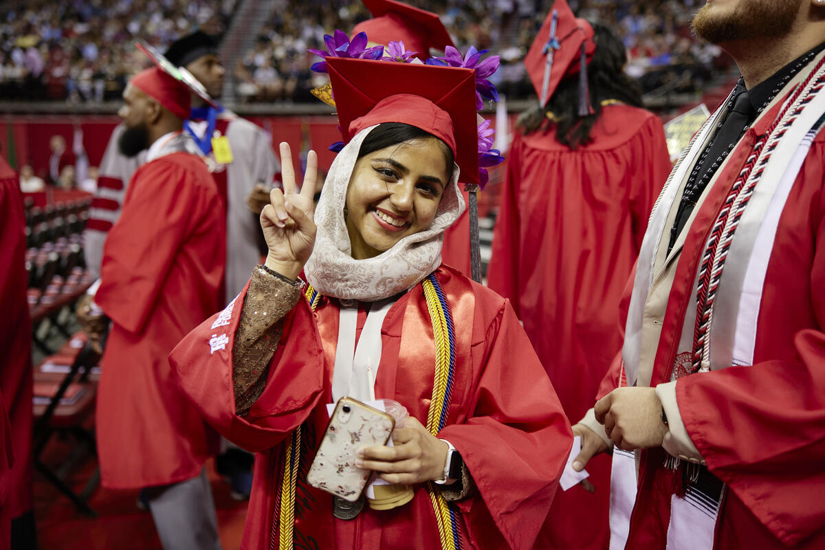 student wearing graduation regalia at the ceremony