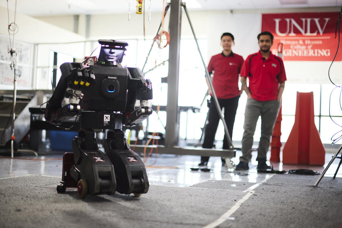 Two people inside a robotics lab
