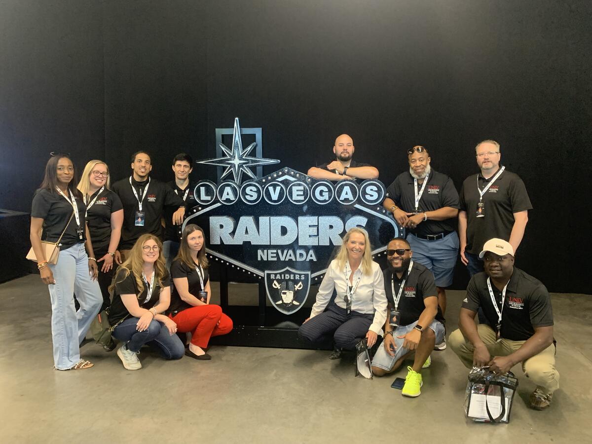 EMBA by the Las Vegas Raider sign