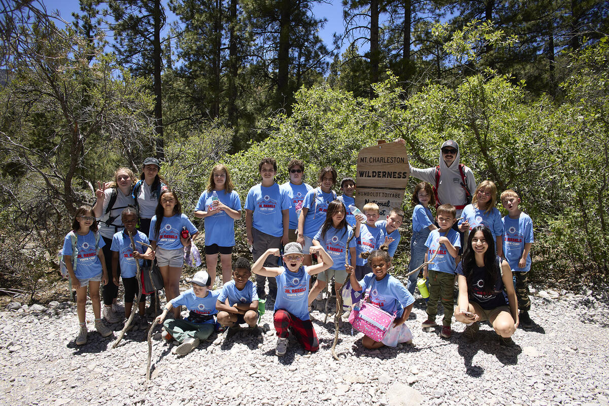 Group picture of children on a camping trip wearing matching shirts