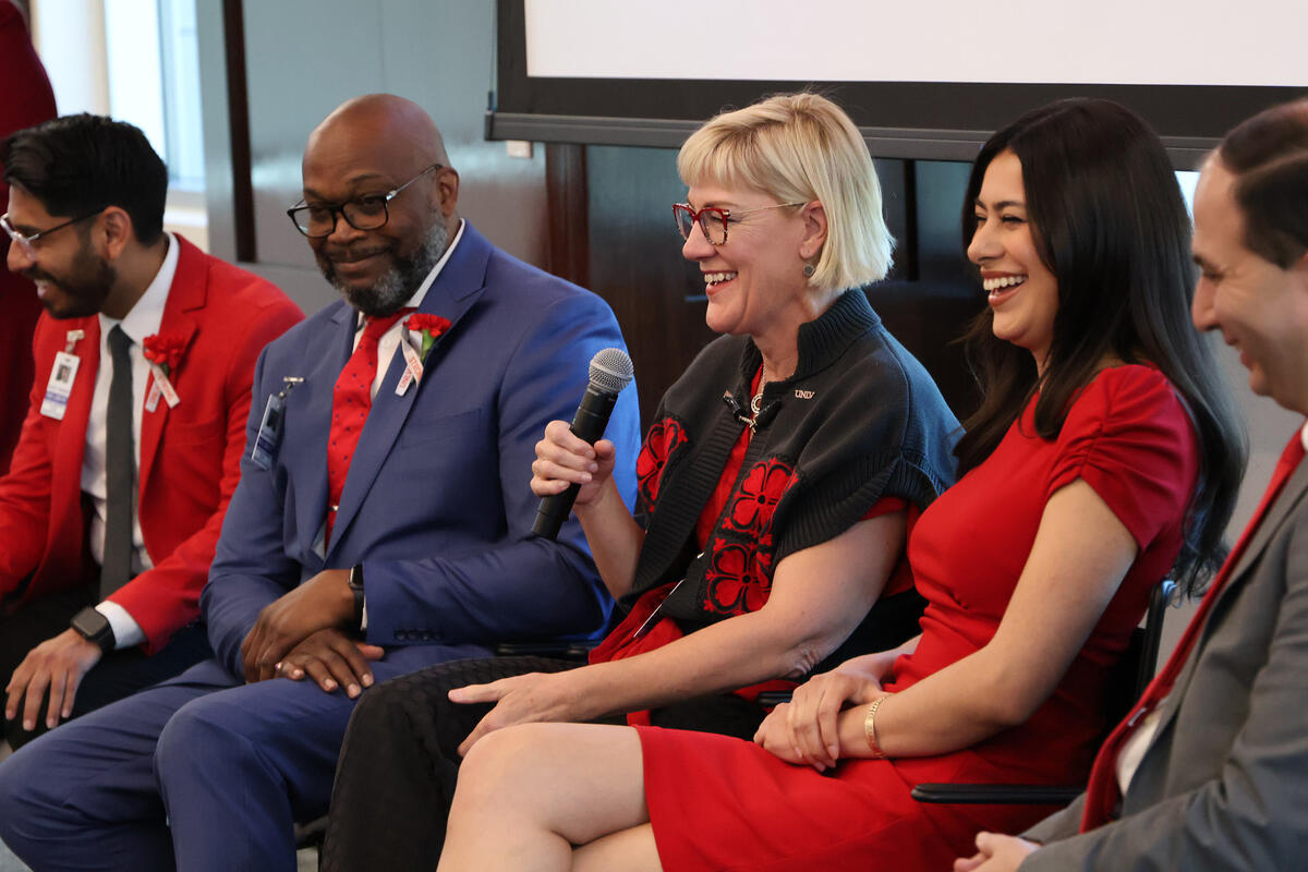 Photo if people seated in lined up chairs