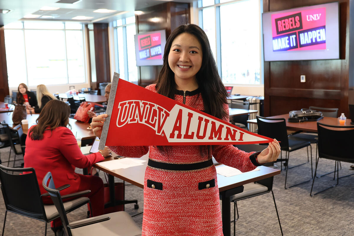 Photo of a person cholding a UNLV Alumni Flag