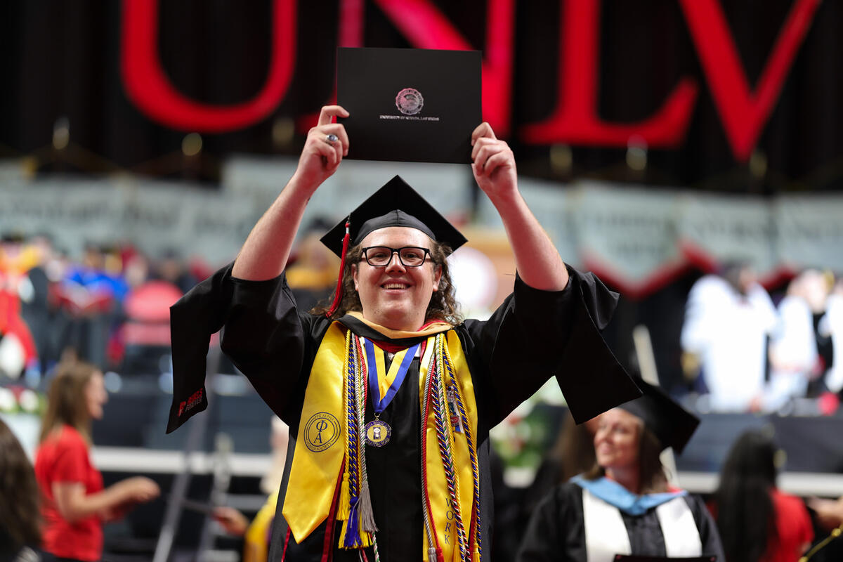 M.S. student holding up degree
