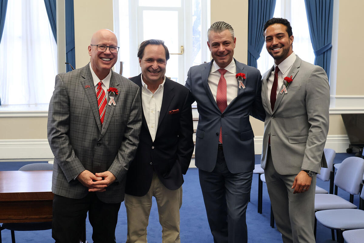 Four men in suits and ties
