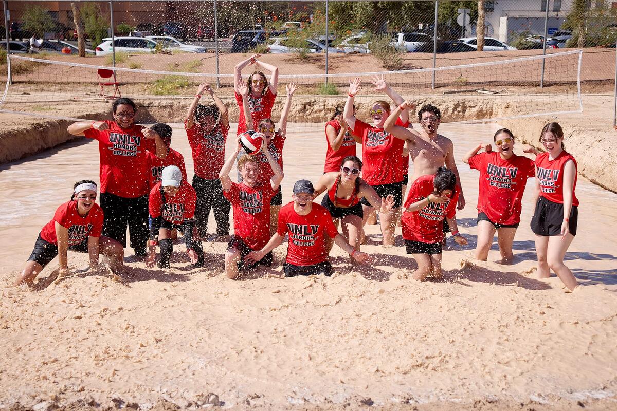 Students playing Oozeball in muddy water