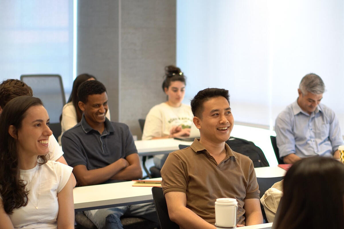 A group of students laughing during a lecture.