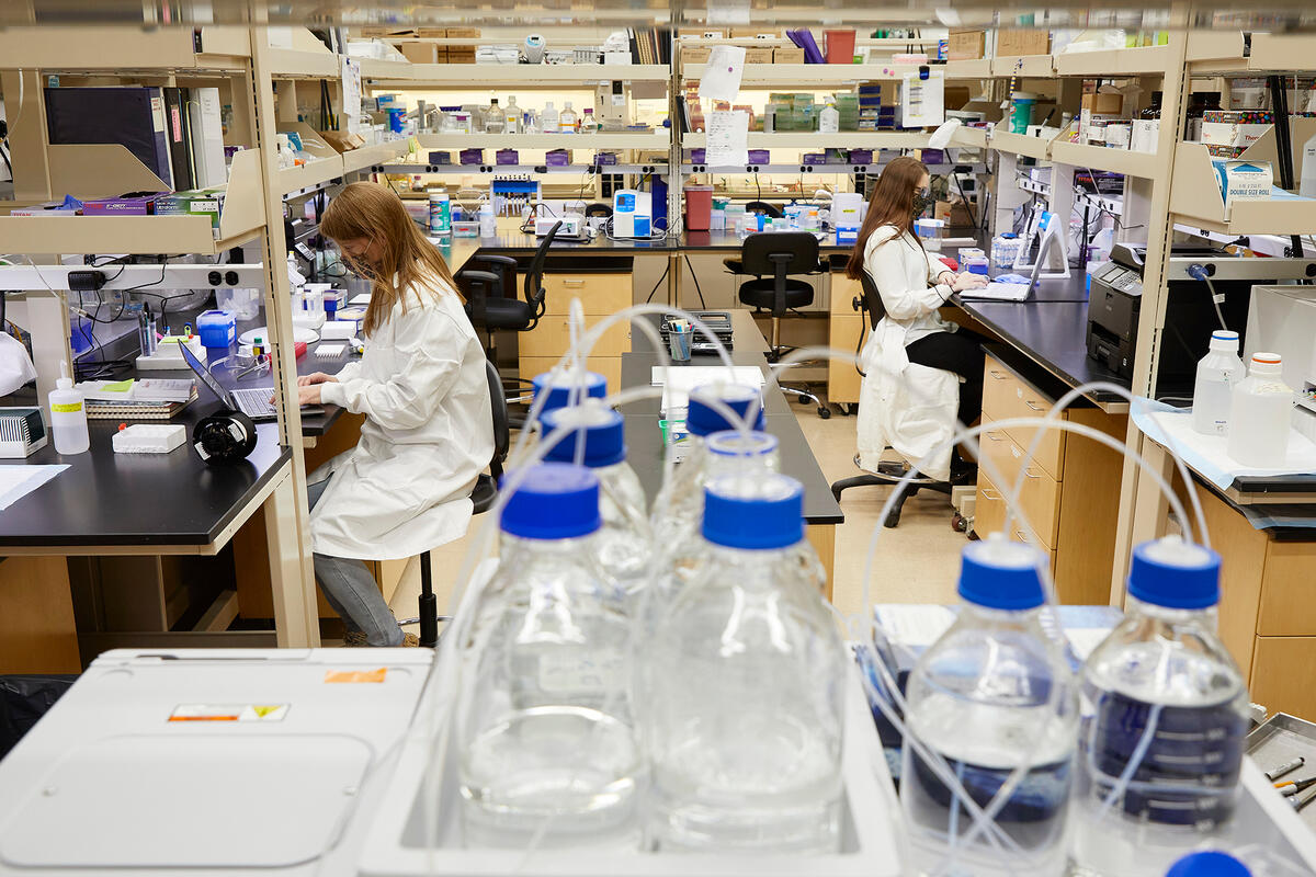 Two people sitting inside a lab