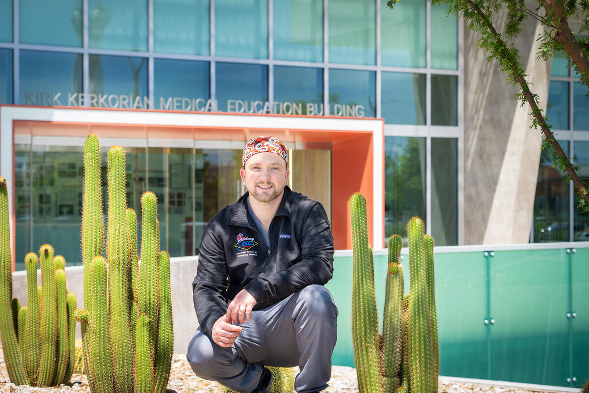 Student posed in front of the Kirk Kerkorian Medical Education Building