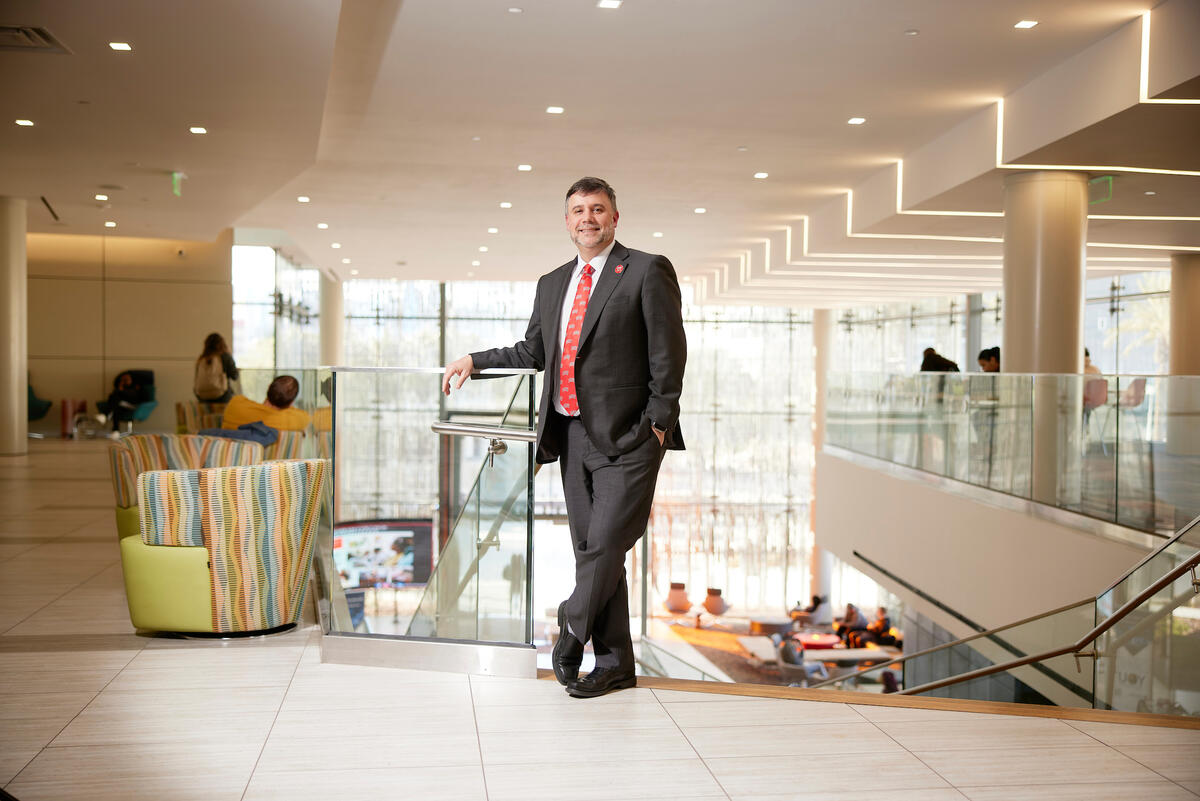 David Cardenas at top of staircase in hospitality college building
