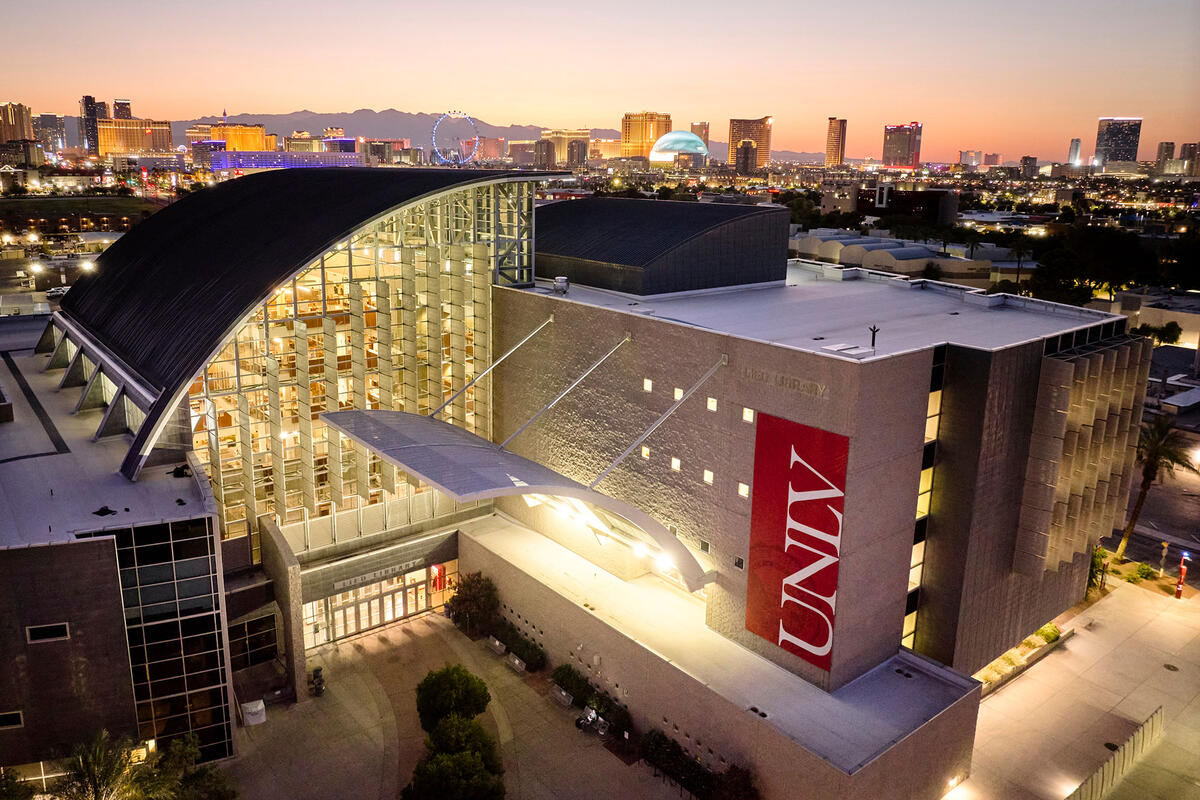 Aerial view of the UNLV Lied Library at sunset, with the Las Vegas Strip in the background.