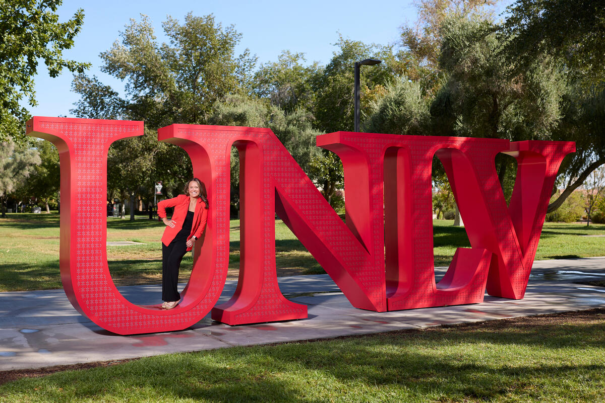 Susan Yunkes inside the "U" of UNLV letters on campus