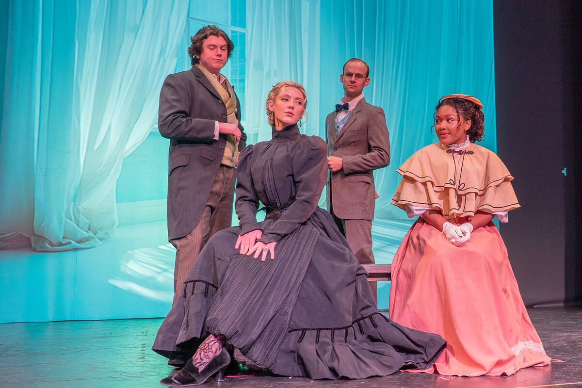 four costumed cast members in Hedda Gabler play