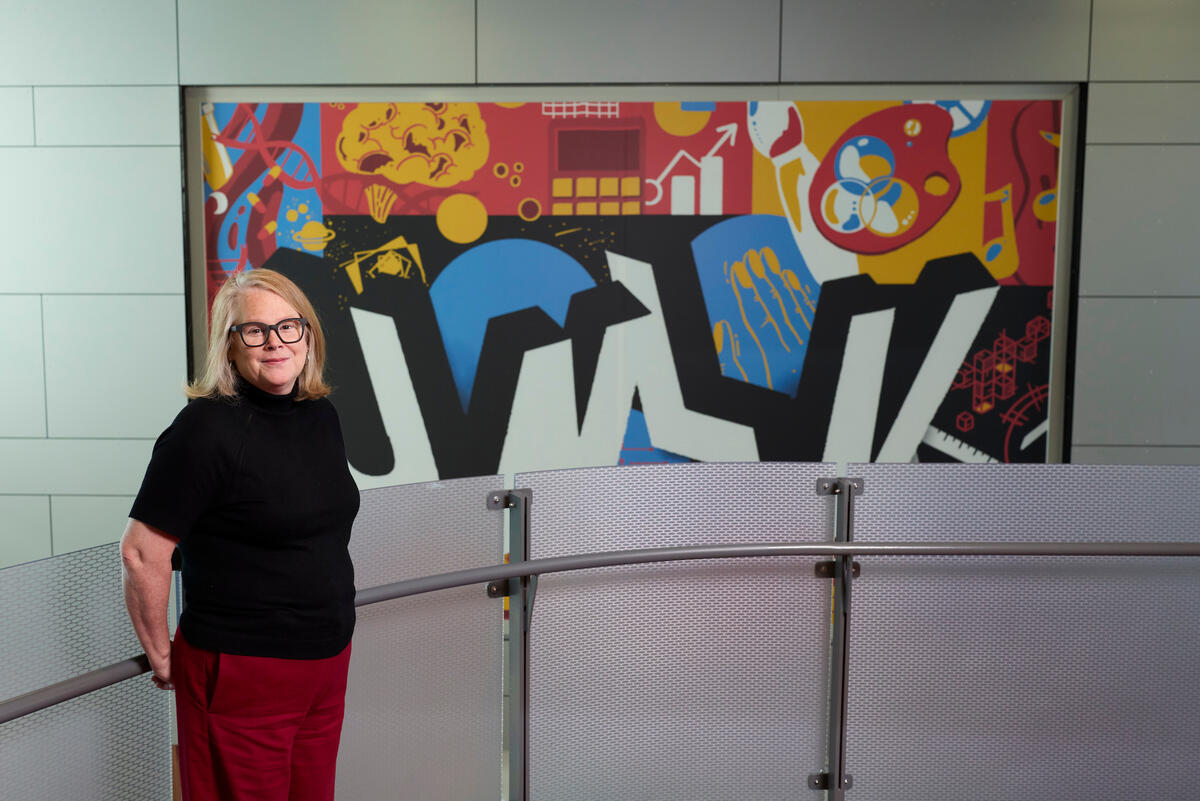 Adrianne Smith in front of a colorful mural