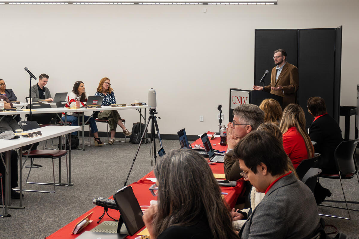 A group of people in a room attending a meeting