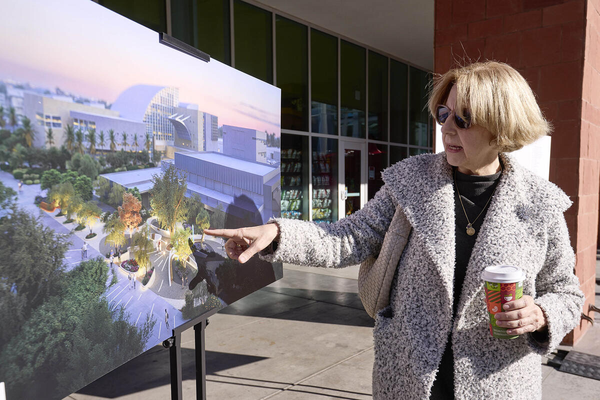 woman viewing rendering on a stand at outdoor event