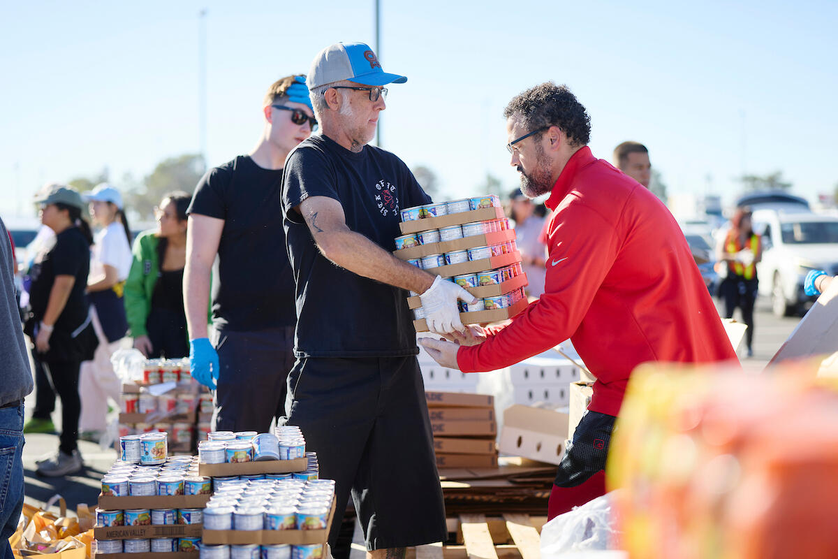 two adults organizing and distributing food at event
