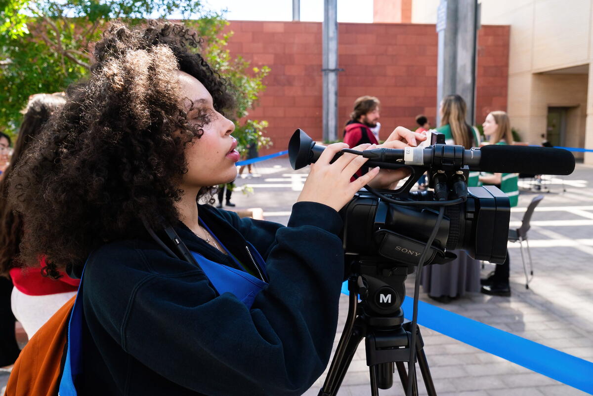 Photo of a student holding a camera