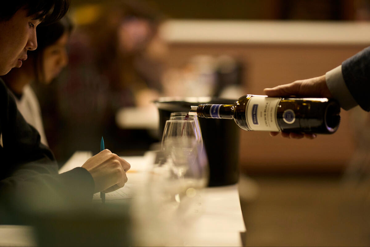Wine being poured into a glass.