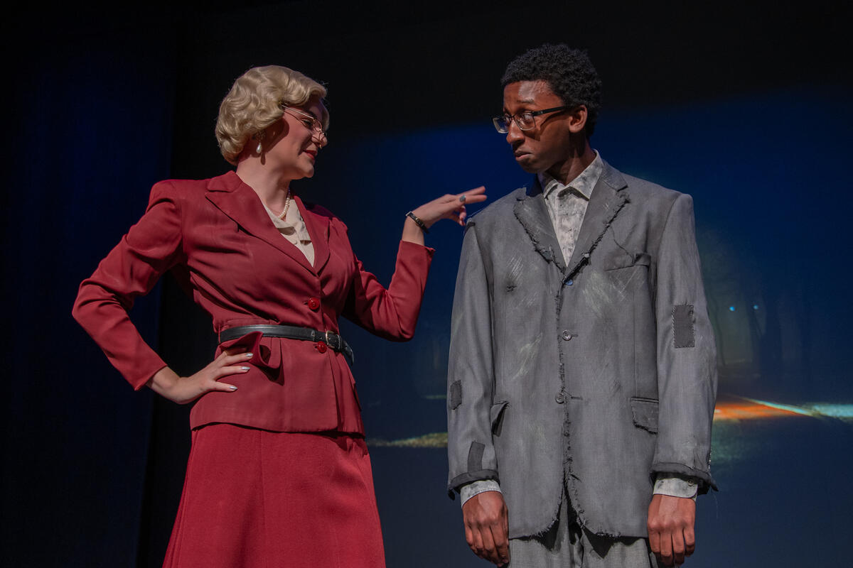 two actors in costume on a stage