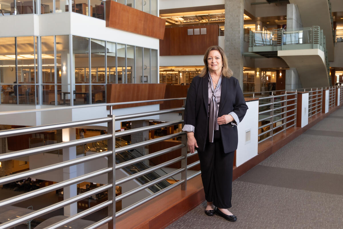Lorri Jackson stands against railing in Lied Library