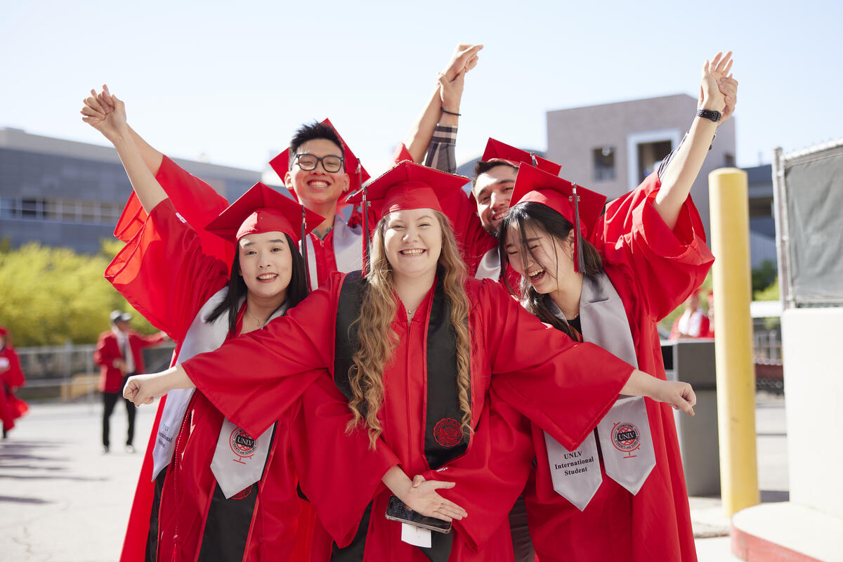 international students in graduation robes