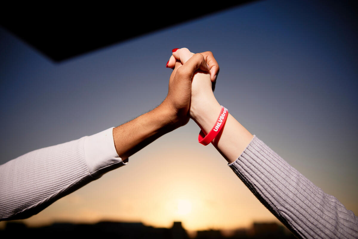 Two hands holding in the air
