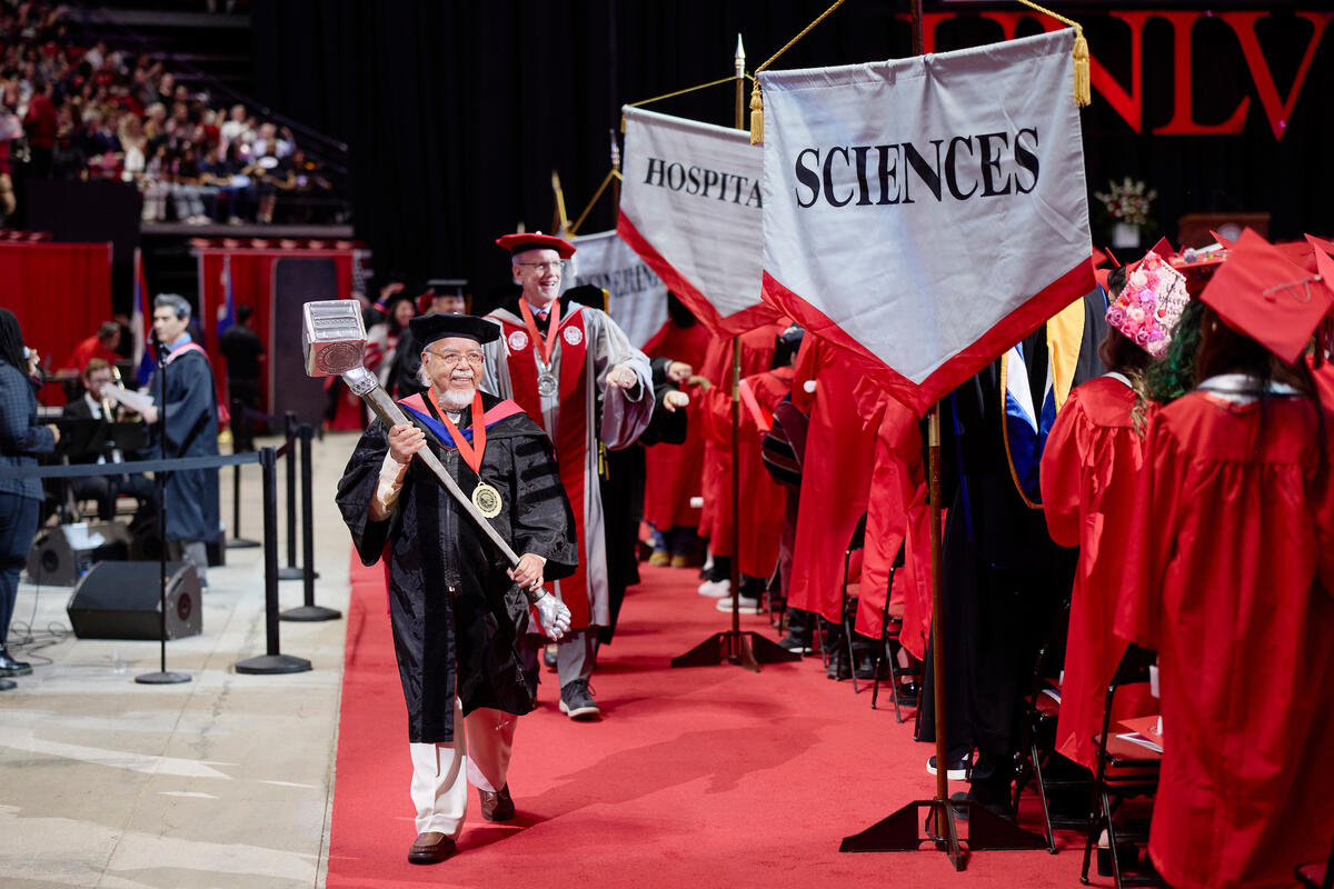 Satish carrying ceremonial mace during commencement ceremony