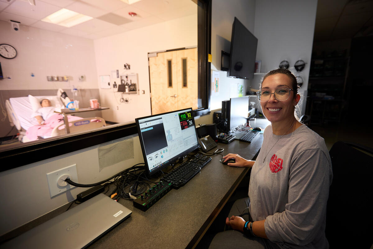 Lisa Lindquist-Nicholas at the Clinical Simulation Center where manikin is seen through window
