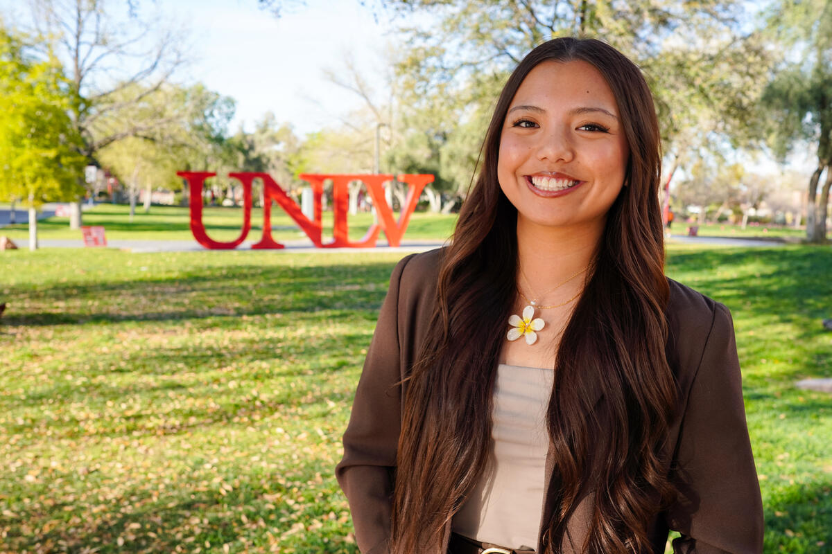 Ramhae Await in front of UNLV sign on campus