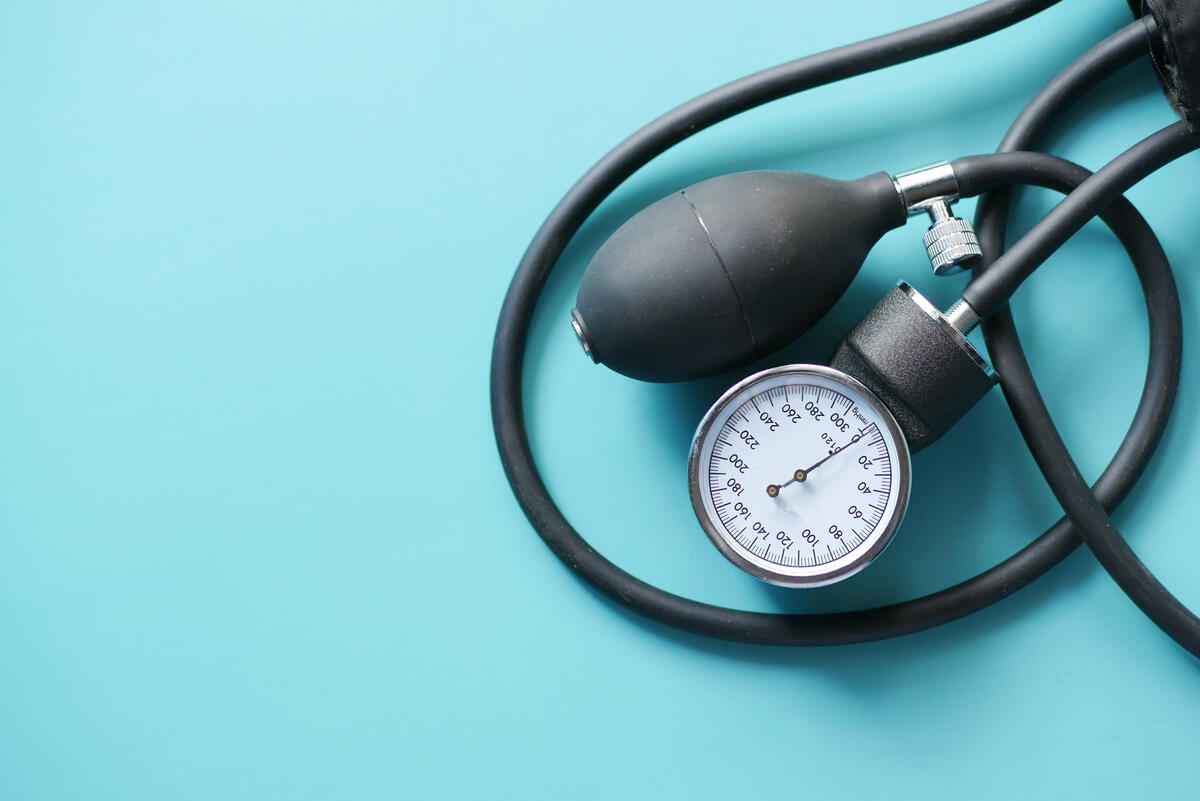 blood pressure cuff against light blue backdrop