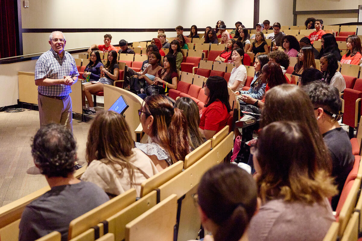 A professor speaking in front of a classroom
