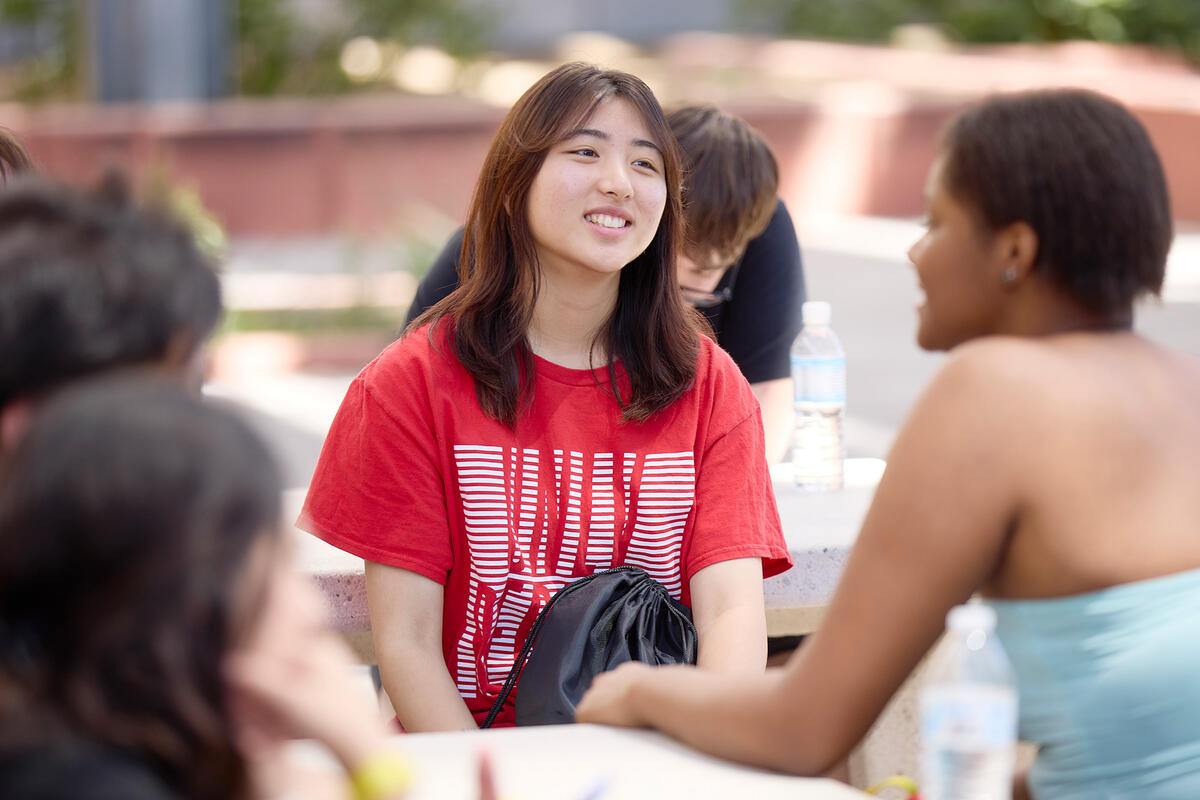 Students sitting outside while discussing.