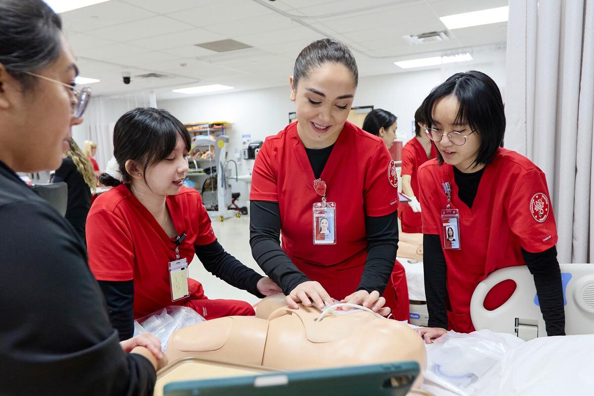Photo of people wearing red scrubs in a lab