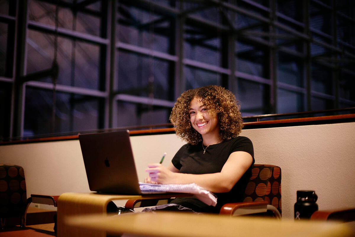 Smiling student studying at the Lied Library