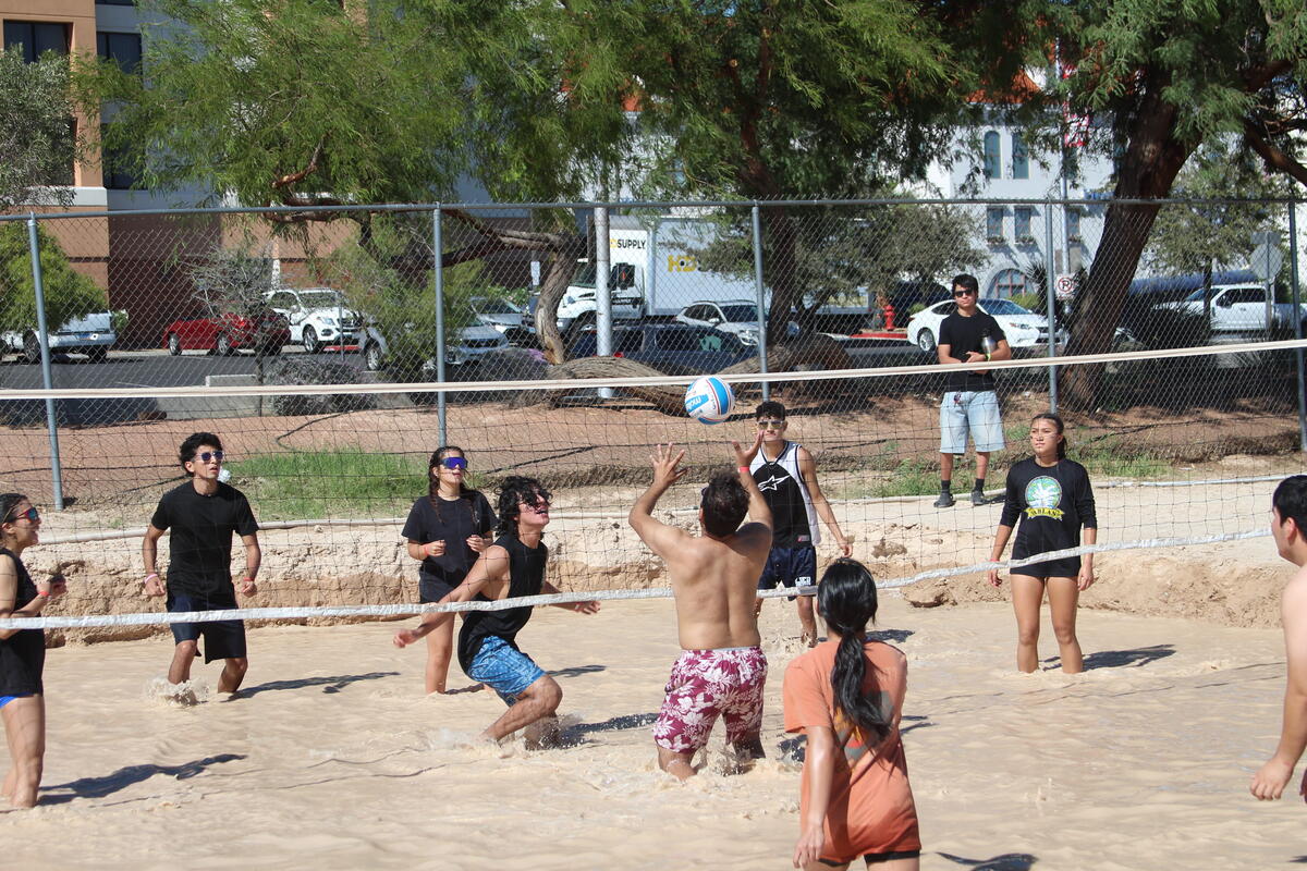 Photo of people playing volleyball in knee high dirty water