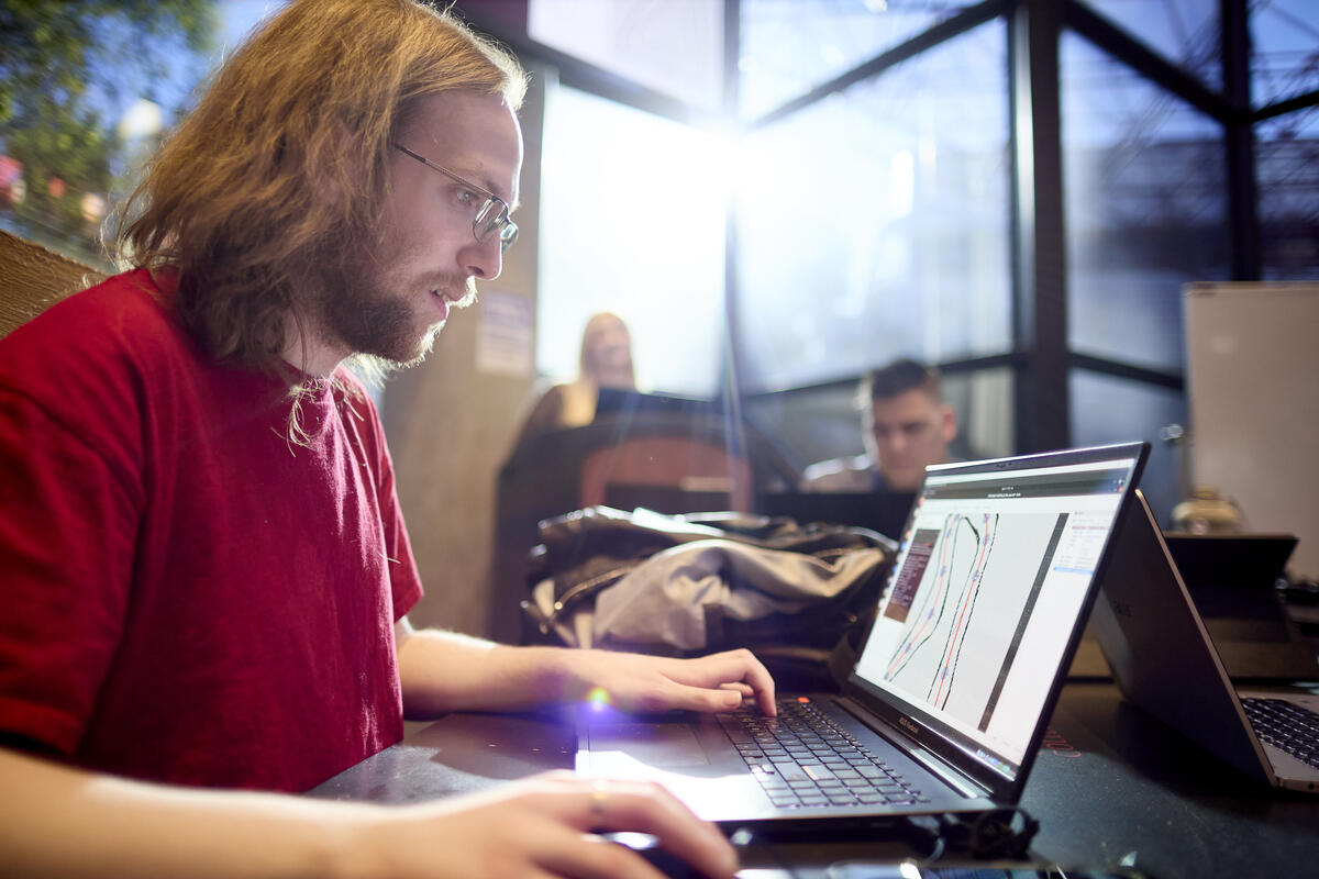 A man sitting at a table with a laptop