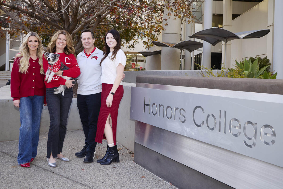 Engle family in front of Honors College sign