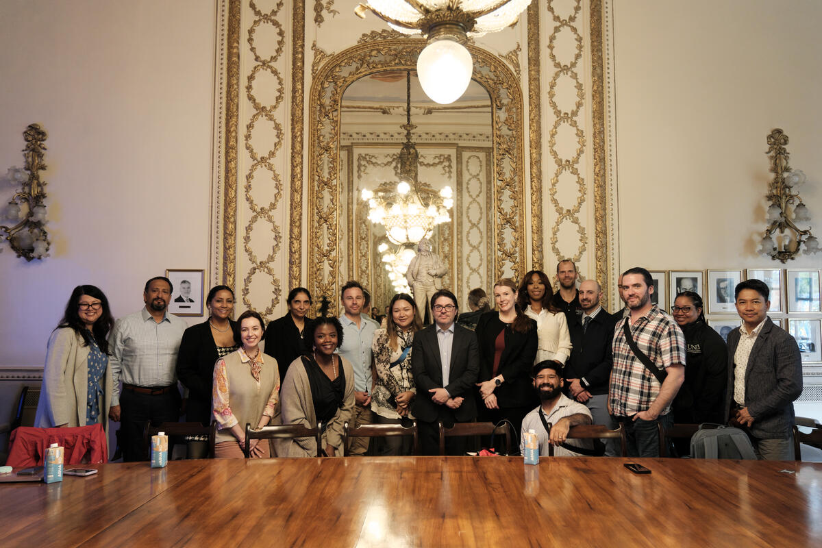 A group of people posing behind a large table