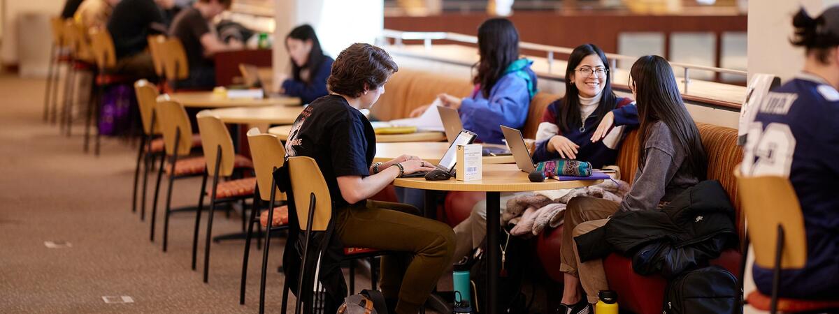 Students sitting at a table and talking