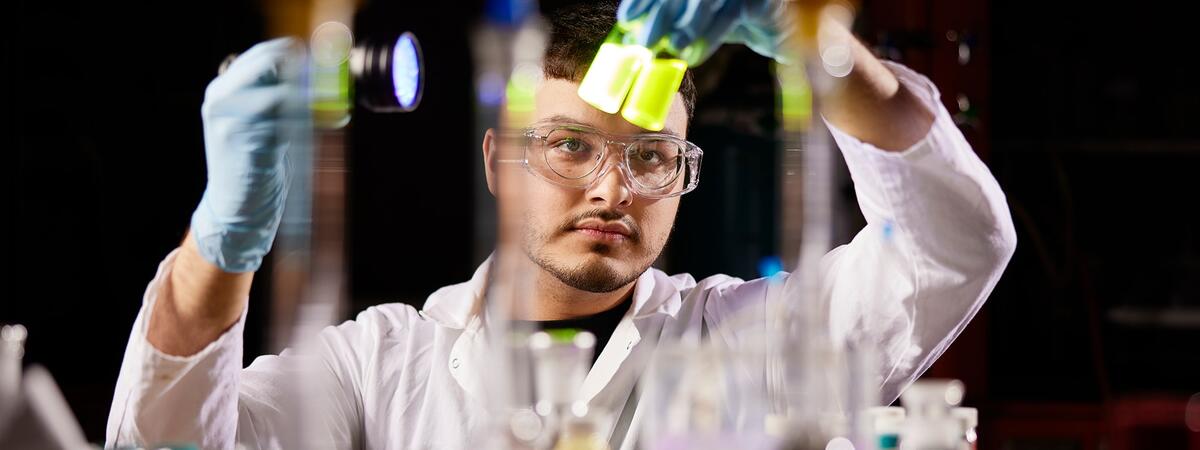 Student in lab working with beakers