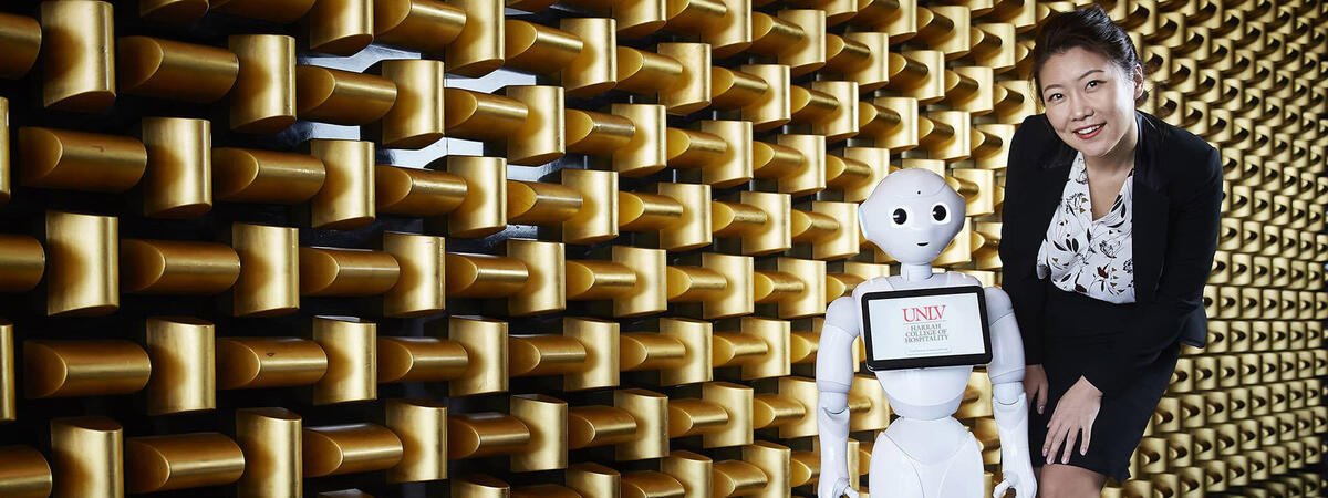 Professional woman standing next to a robot