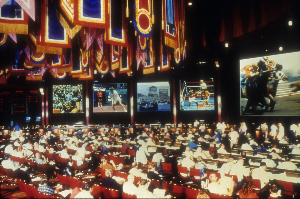People inside of the Olympiad Race and Sports book at the Caesars Palace Hotel and Casino in the 1980s