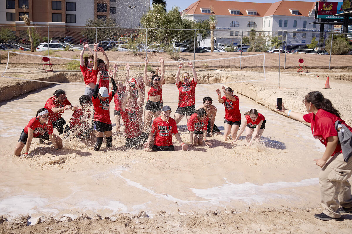 Students celebrating in the center of an oozeball court