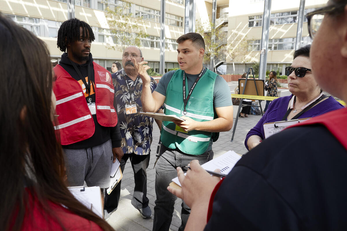 A group of people standing outside with clipboards