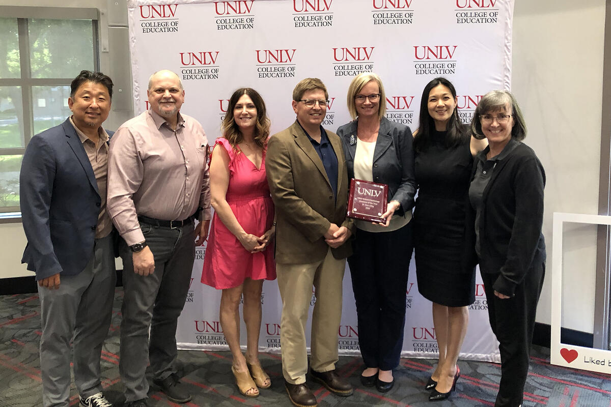 people standing in front of a UNLV backdrop 