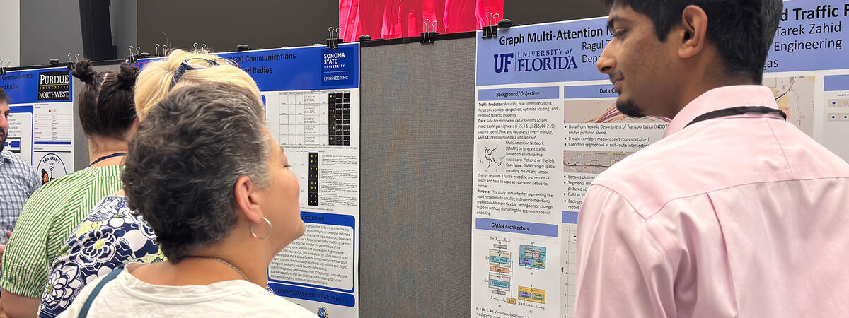 A group of people looking at a research board