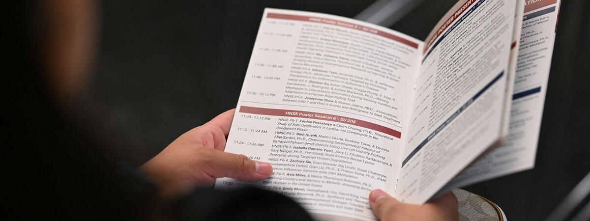 A person holding up a pamphlet