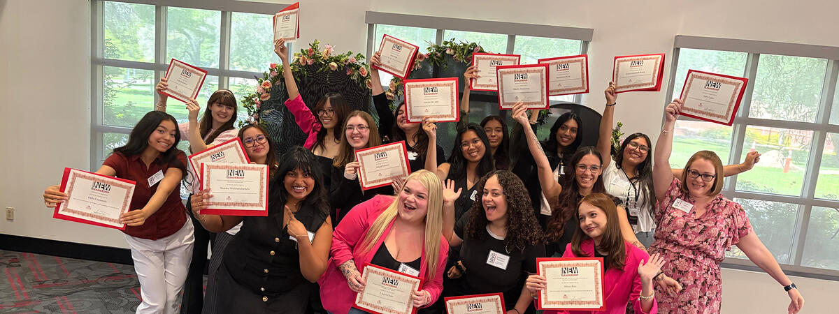 A group of women posing together while holding up certificates