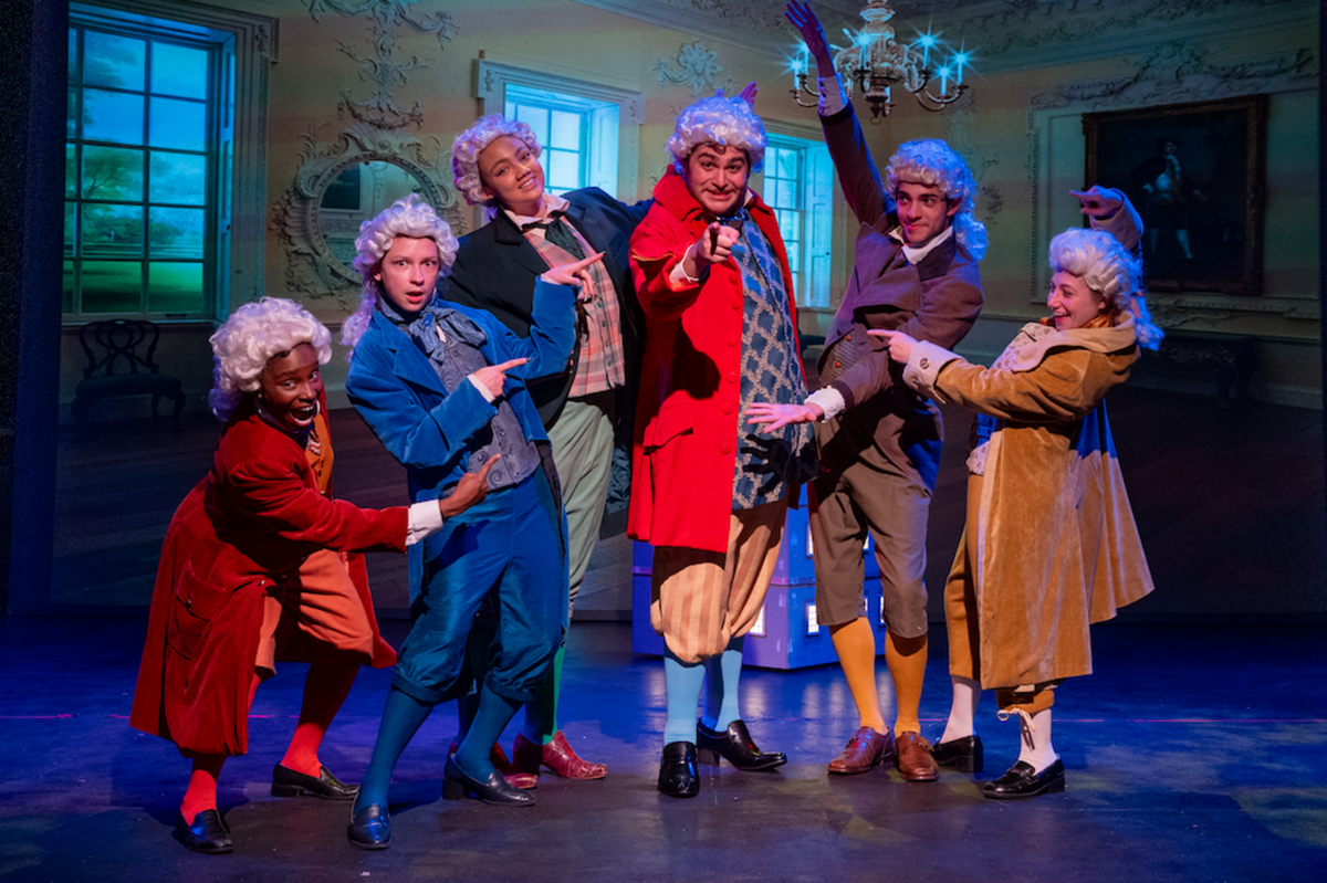 group of costumed actors on stage